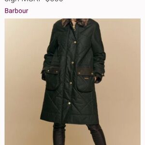 Barbour Green oilskin jacket with fur trim on the hood.